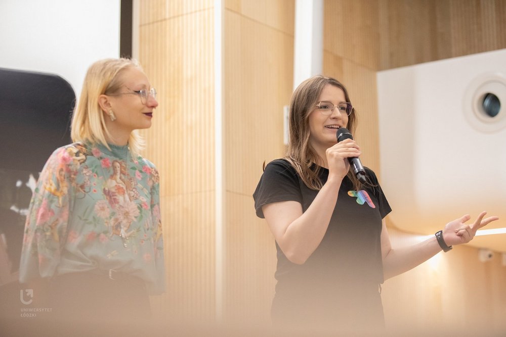 A student in a black T-shirt delivering a speech