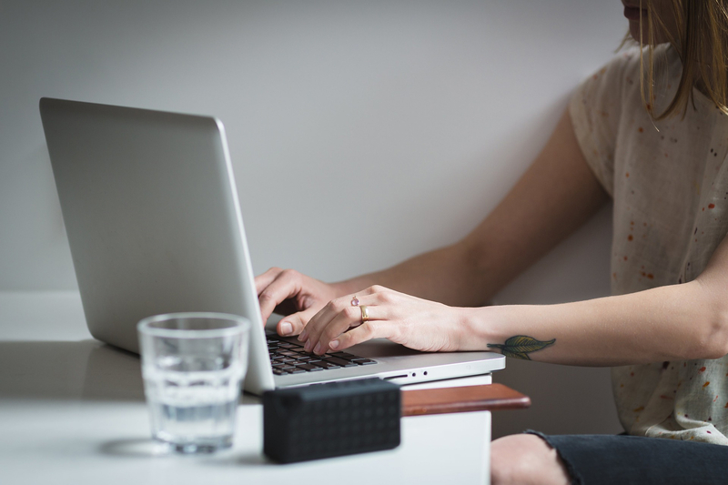 A girl typing on a laptop keyboard