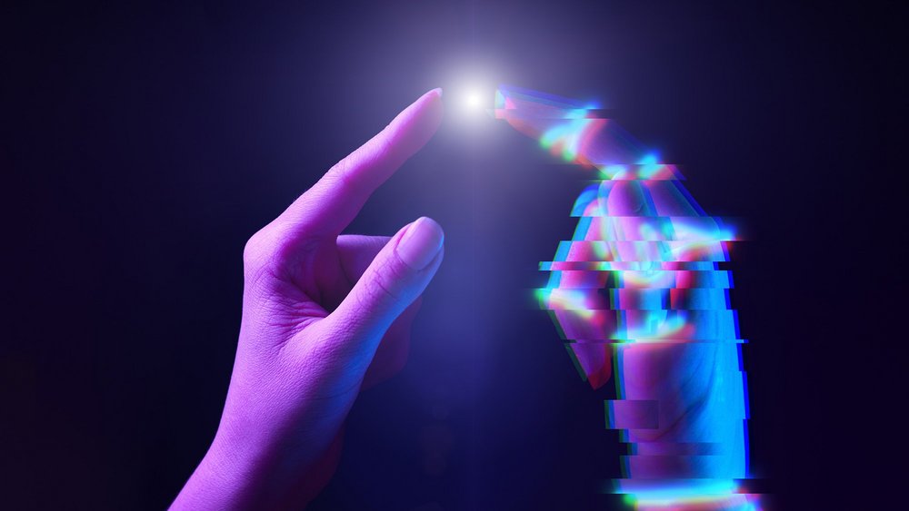 a decorative element: two hands with their fingers touching, one with a digital effect